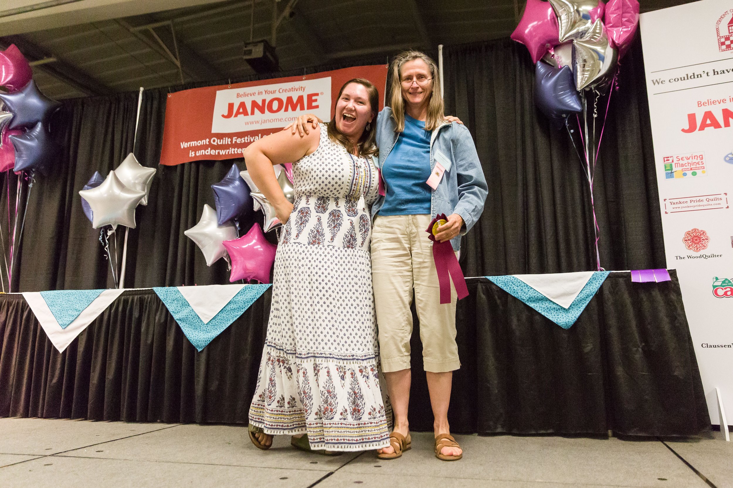 Social Media Coordinator Trista Ringer stands next to a ribbon winner